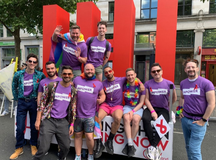 MPOWER Volunteers at Dublin Pride beside a large U=U float